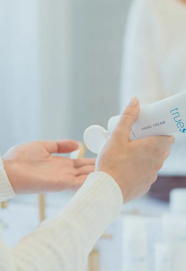 Woman putting on Hand Cream