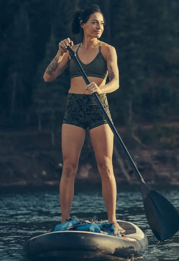 Woman paddleboarding on calm water