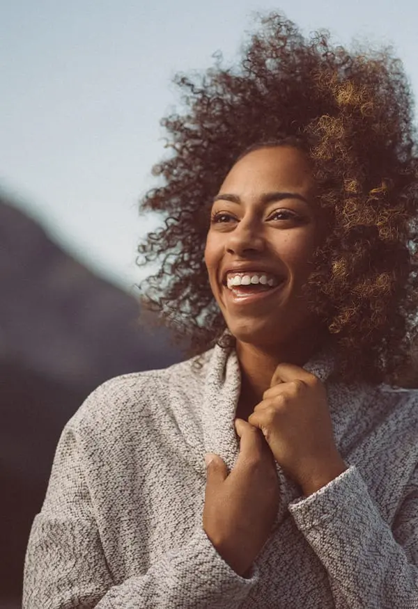 Smiling young woman with curly hair